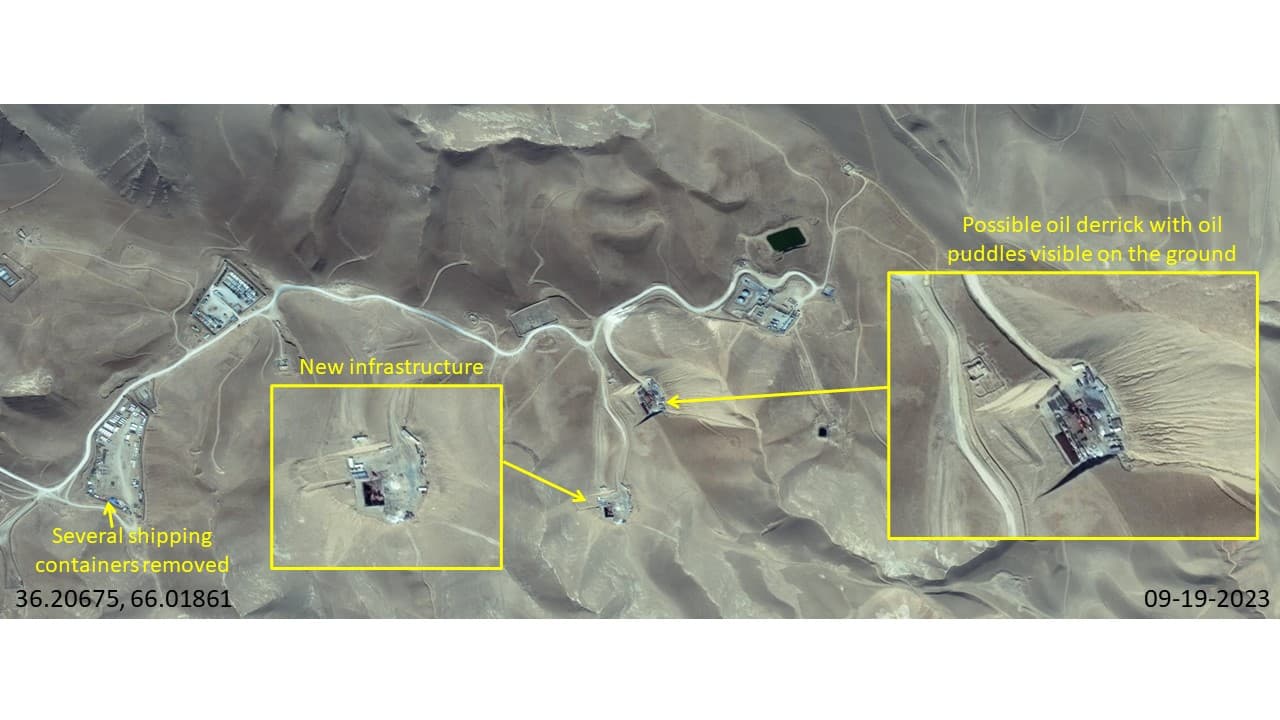 A possible oil derrick (drilling tower) has been constructed in the center, with possible oil puddles on the ground around it. A clearing just below the derrick has also been developed with new constructions on it.